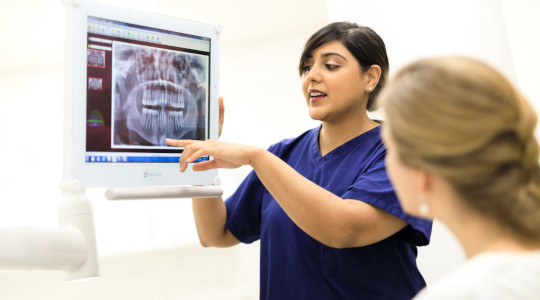 Bupa Dental Care dentist showing patient scan