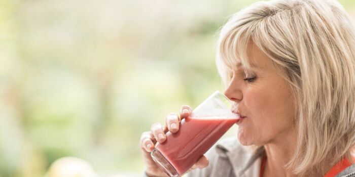 woman drinking a fruit smoothie